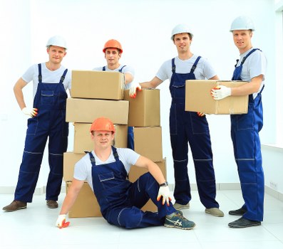 Professional furniture pick-up team handling an awkward stairwell collection
